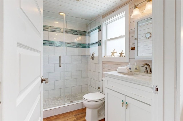 bathroom with vanity, hardwood / wood-style flooring, toilet, and an enclosed shower