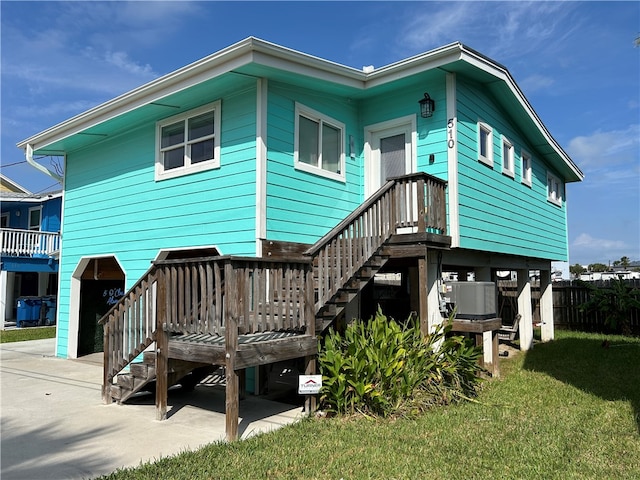 rear view of house with a lawn, a patio area, and central AC unit