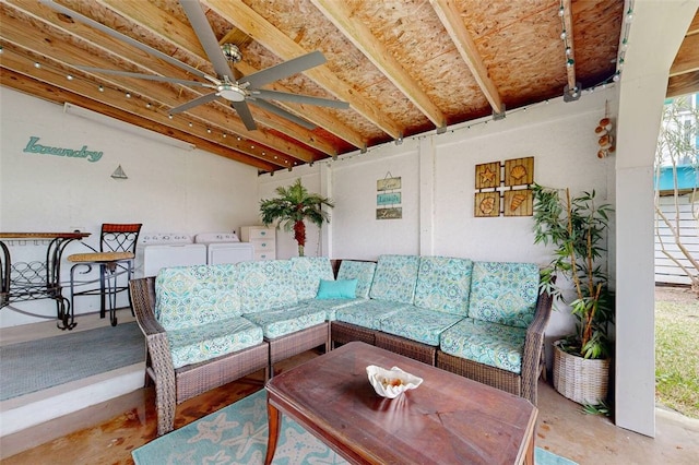 living room with washing machine and clothes dryer and ceiling fan