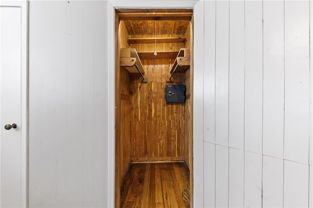 mudroom with wood walls and hardwood / wood-style floors