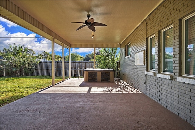 view of patio / terrace featuring ceiling fan and a hot tub