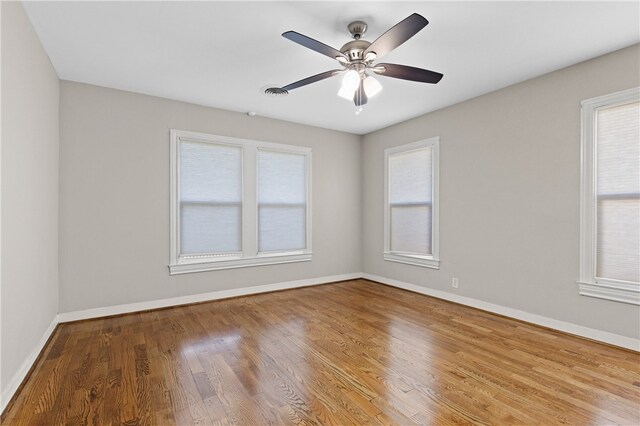 unfurnished room with hardwood / wood-style flooring and ceiling fan