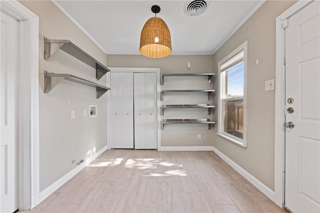 foyer featuring crown molding