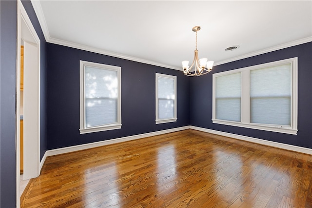 unfurnished room featuring a notable chandelier, hardwood / wood-style flooring, and crown molding