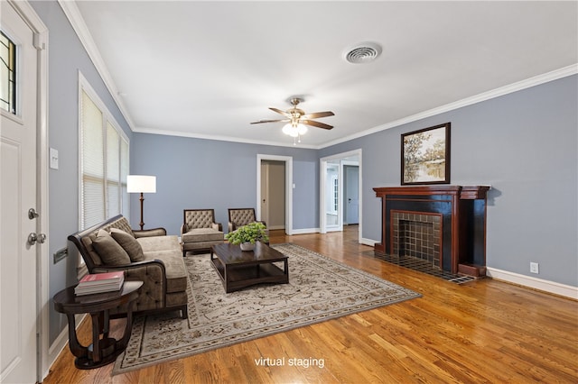 living room featuring ceiling fan, wood-type flooring, and ornamental molding