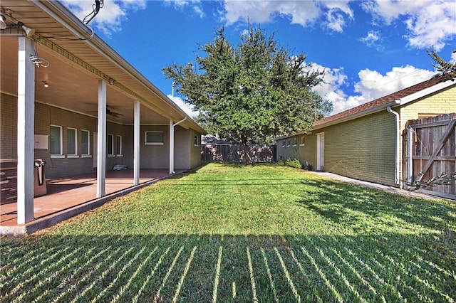 view of yard featuring a patio and ceiling fan