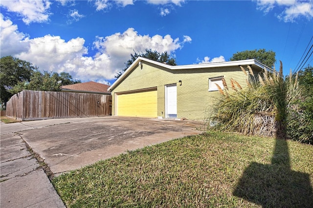 view of property exterior featuring a lawn and a garage