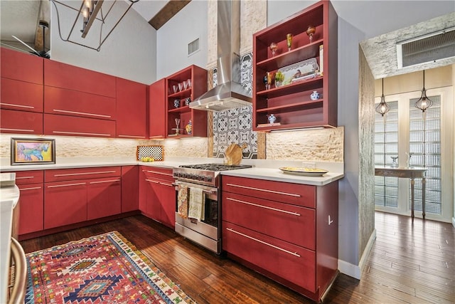 kitchen with high end range, backsplash, range hood, and dark wood-type flooring