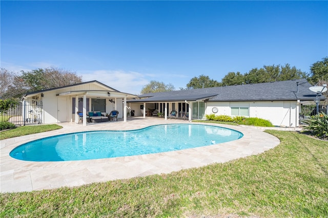 view of swimming pool with a yard, an outdoor living space, and a patio