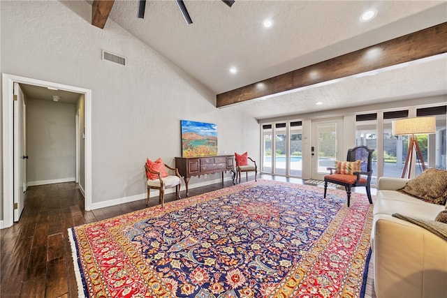 living room featuring a textured ceiling, lofted ceiling with beams, and dark hardwood / wood-style floors