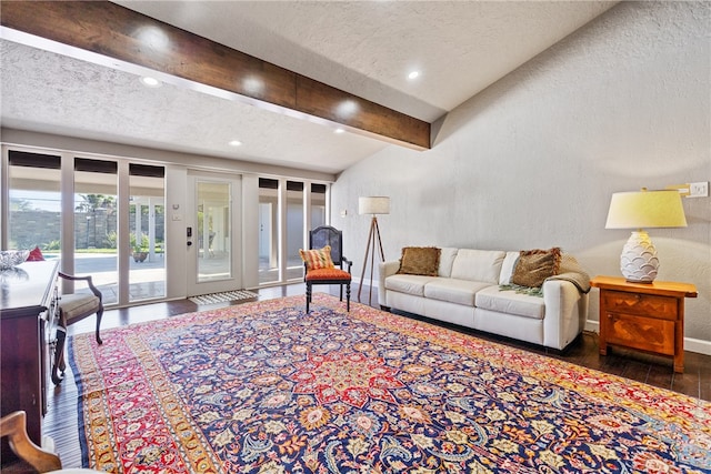 living room featuring a textured ceiling, lofted ceiling with beams, and dark hardwood / wood-style floors