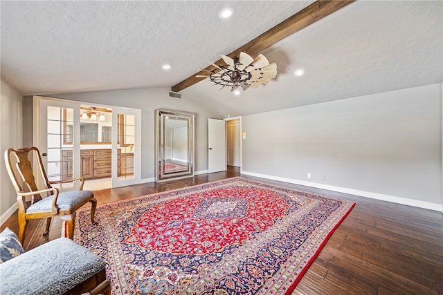 sitting room with french doors, a textured ceiling, ceiling fan, hardwood / wood-style floors, and vaulted ceiling with beams