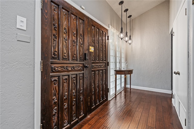 wine room with dark hardwood / wood-style floors and lofted ceiling