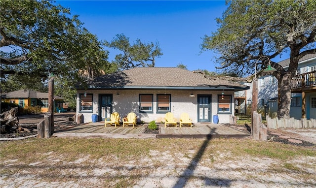 130 Prairie, Rockport, TX 78382 - back of property featuring an outdoor fire pit and a deck