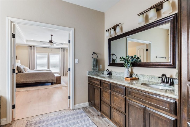 ensuite bathroom featuring double vanity, ceiling fan, a sink, and ensuite bathroom