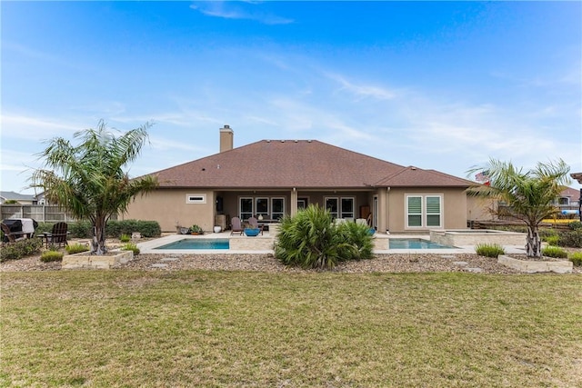 rear view of house with a fenced in pool, a patio area, a yard, and stucco siding