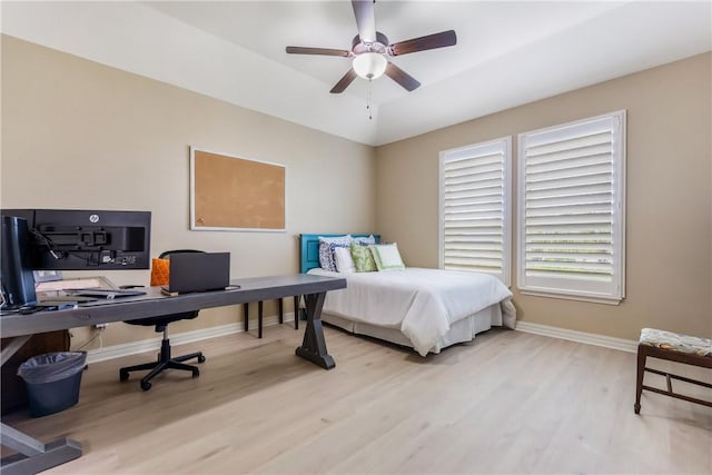 bedroom featuring wood finished floors, a ceiling fan, and baseboards