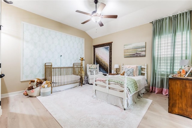 bedroom with baseboards, a ceiling fan, vaulted ceiling, and wood finished floors