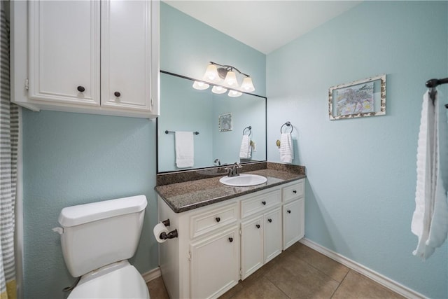 bathroom with vanity, tile patterned floors, and toilet