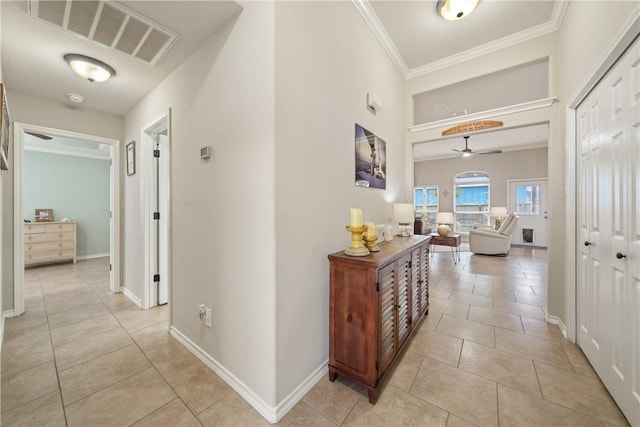 hallway with light tile patterned flooring and ornamental molding