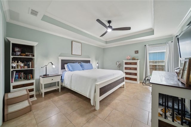 tiled bedroom featuring crown molding, ceiling fan, and a raised ceiling