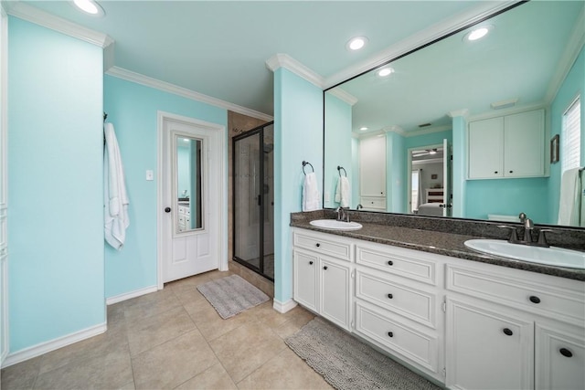 bathroom featuring tile patterned flooring, crown molding, vanity, and walk in shower