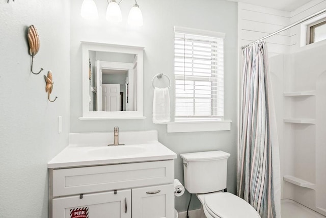 bathroom featuring toilet, a shower with curtain, and vanity