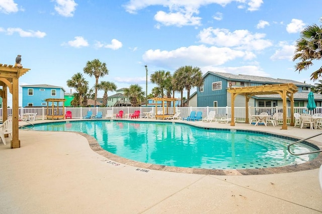 pool featuring fence, a pergola, and a patio