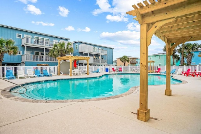 community pool featuring a pergola, a patio, and fence