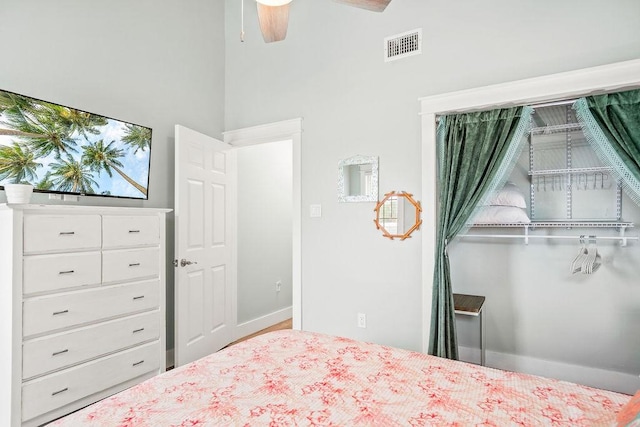 bedroom featuring a ceiling fan, visible vents, and baseboards