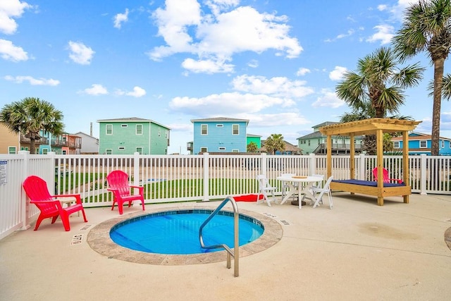 view of swimming pool with a patio area, a jacuzzi, and fence