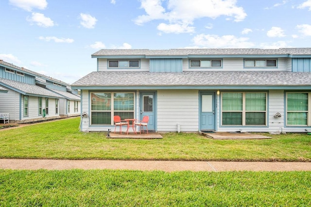 view of front of home with a front lawn and roof with shingles