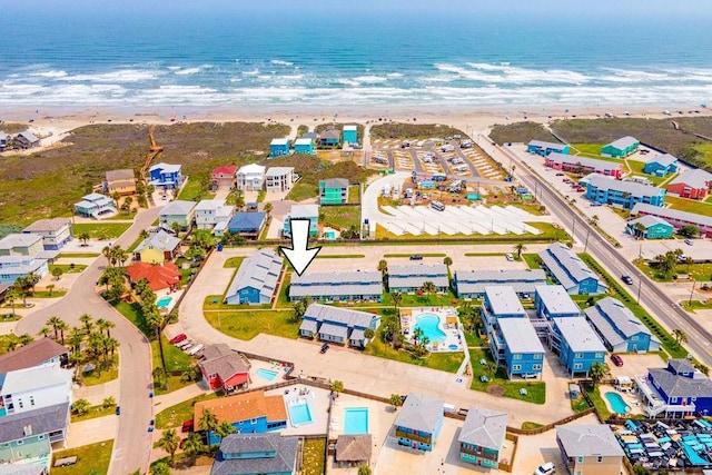 birds eye view of property with a view of the beach and a water view