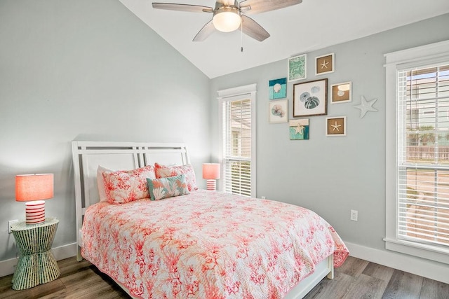 bedroom featuring a ceiling fan, baseboards, vaulted ceiling, and wood finished floors