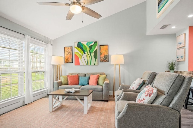 living room with visible vents, vaulted ceiling, and ceiling fan