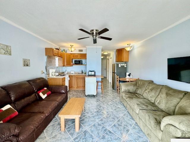 living room featuring crown molding and ceiling fan