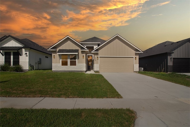 3629 Rebecca Dr, Corpus Christi, TX 78410 - view of front of house with board and batten siding, driveway, a front yard, stone siding, and a garage
