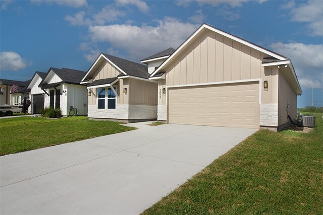 3629 Rebecca Dr, Corpus Christi, TX 78410 - view of front of house featuring board and batten siding, a garage, a front lawn, stone siding, and concrete driveway
