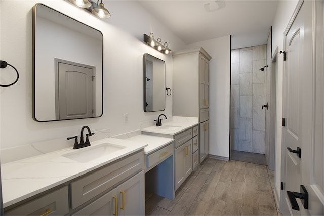 3629 Rebecca Dr, Corpus Christi, TX 78410 - bathroom with double vanity, wood finished floors, and tiled shower