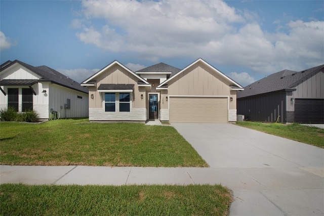 3629 Rebecca Dr, Corpus Christi, TX 78410 - view of front of house with an attached garage, driveway, board and batten siding, a front lawn, and stone siding