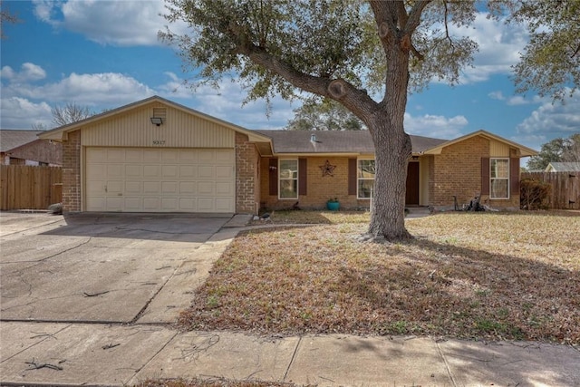 single story home with an attached garage, fence, concrete driveway, and brick siding