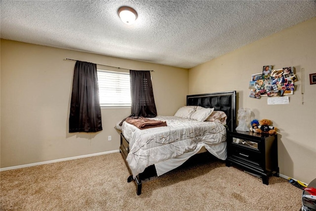 carpeted bedroom with baseboards and a textured ceiling