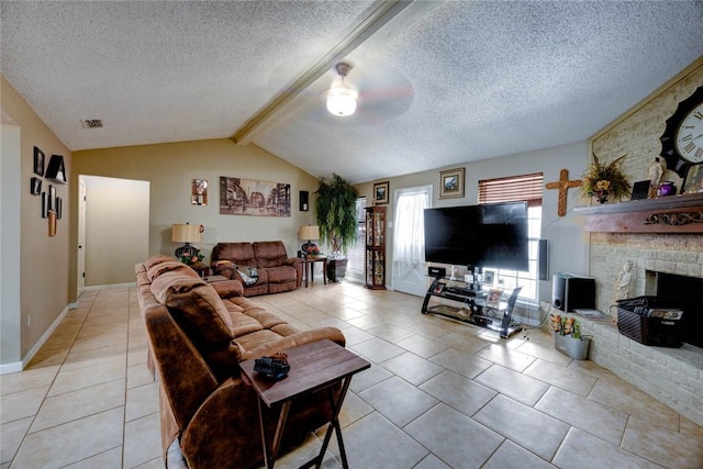 living room featuring lofted ceiling with beams, light tile patterned floors, a large fireplace, and a textured ceiling