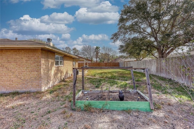 view of yard featuring a vegetable garden and fence