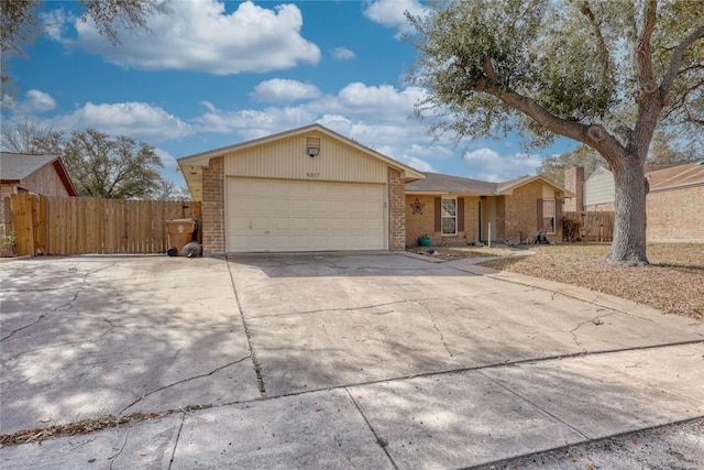 ranch-style home with an attached garage, driveway, fence, and brick siding