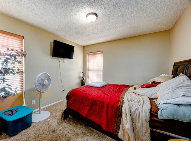 carpeted bedroom featuring baseboards and a textured ceiling