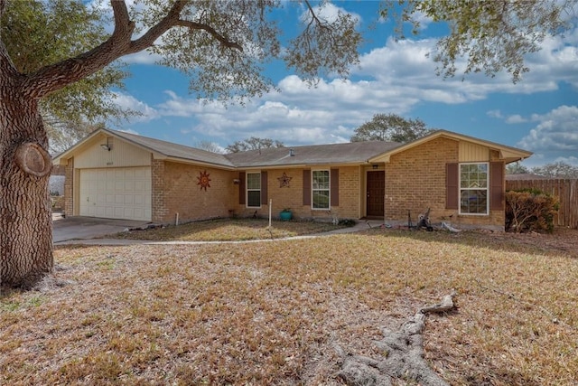 single story home featuring concrete driveway, brick siding, an attached garage, and fence