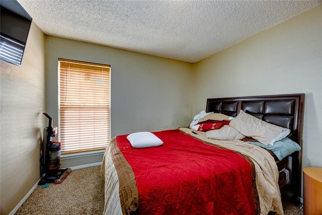 bedroom featuring carpet floors, a textured ceiling, and baseboards