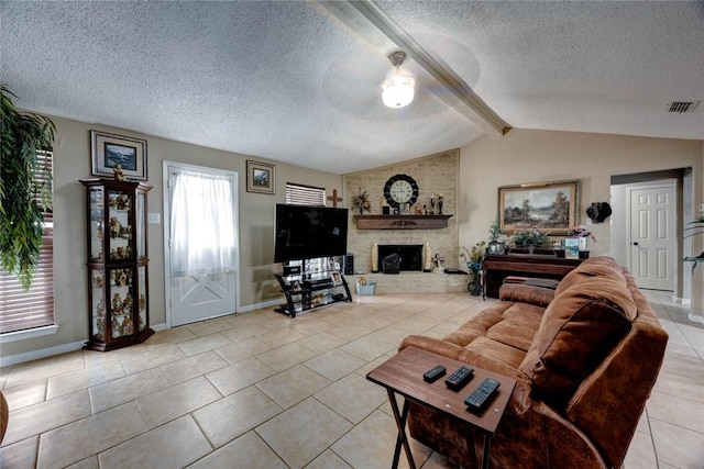 living room featuring visible vents, lofted ceiling with beams, a textured ceiling, a fireplace, and light tile patterned flooring