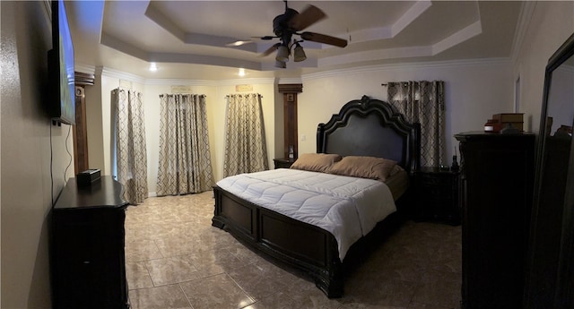 bedroom featuring a tray ceiling, ceiling fan, and crown molding